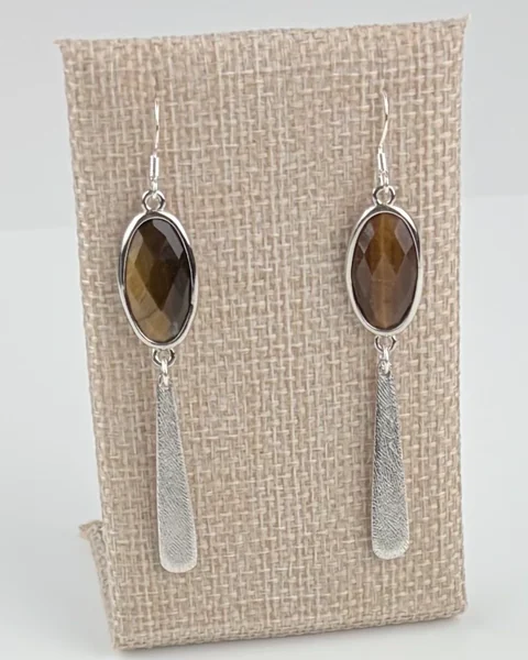 Tiger's Eye Cabochon Dangle Earrings hanging on a linen earring display