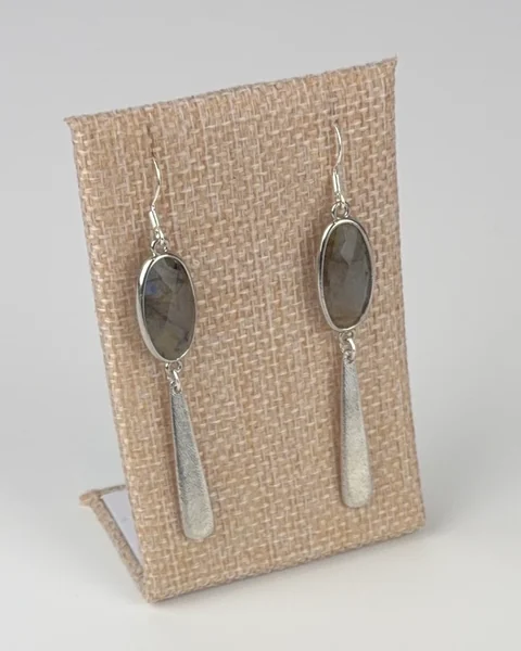 Labradorite Drop Earrings with Etched Bar hanging on a linen earring display