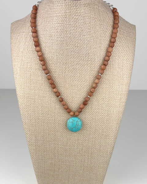 Rosewood and Turquoise Necklace on a linen display bust